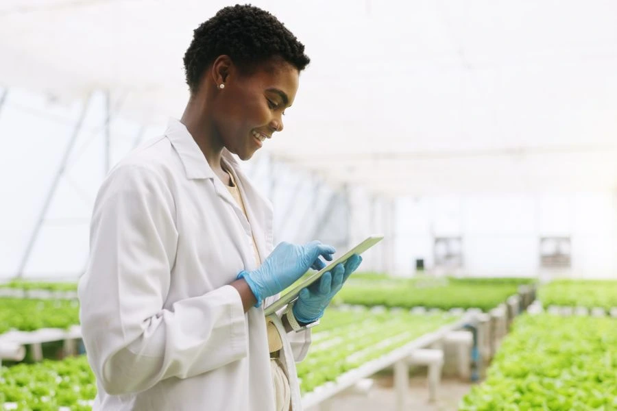Woman checking growing conditions of botanicals